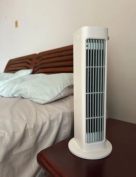 Qinux BreezaMax unit on table alongside of bed